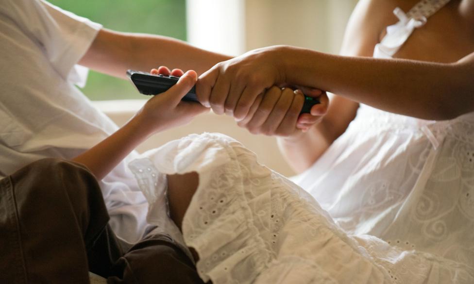 Children fighting over a remote control