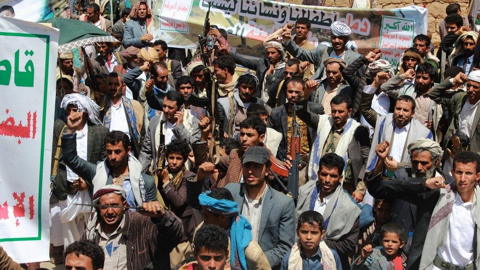 Houthi supporters in Saada raise their rifles and chant slogans at protest against Saudi-led coalition air strike on Dahyan, Yemen (5 September 2018)