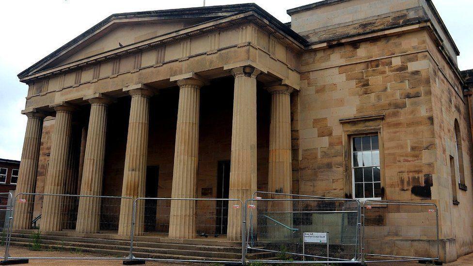 Hereford's Shirehall, a historic building with steps leading up to the entrance and columns at the front.