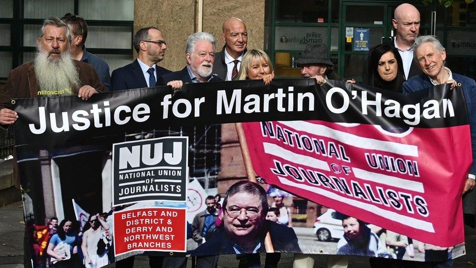 Demonstrators holding a banner depicting Martin O'Hagan at the mayday march before he was killed.