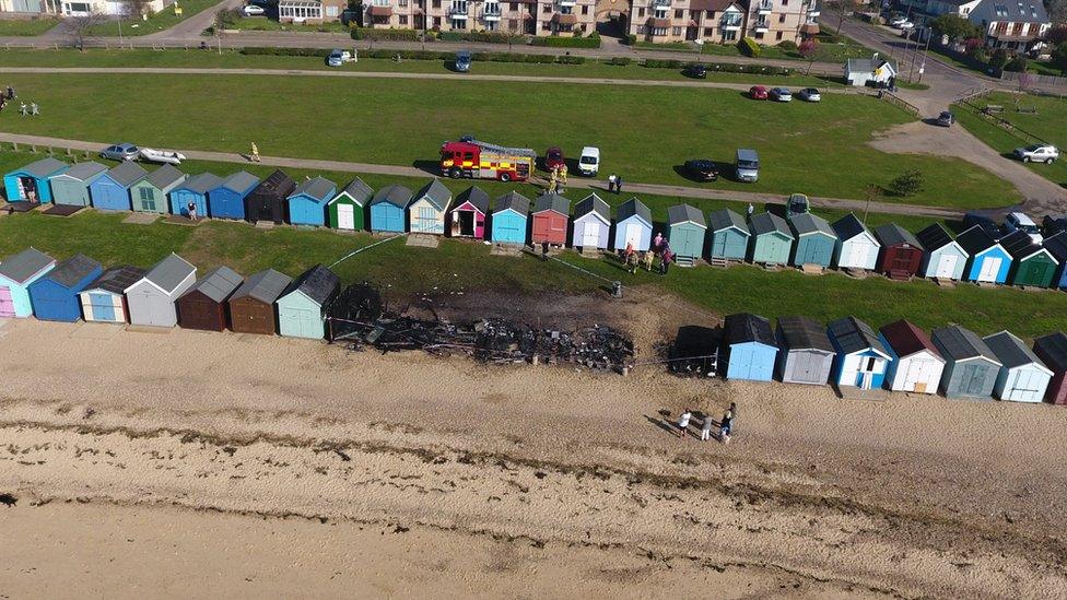 Burnt-out beach huts in West Mersea.