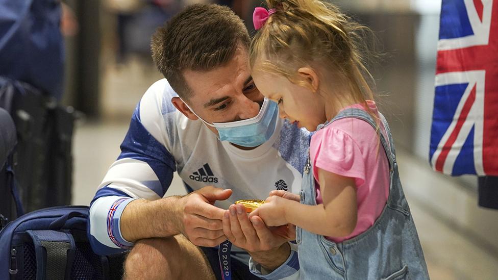 Max Whitlock and daughter at Heathrow Airport