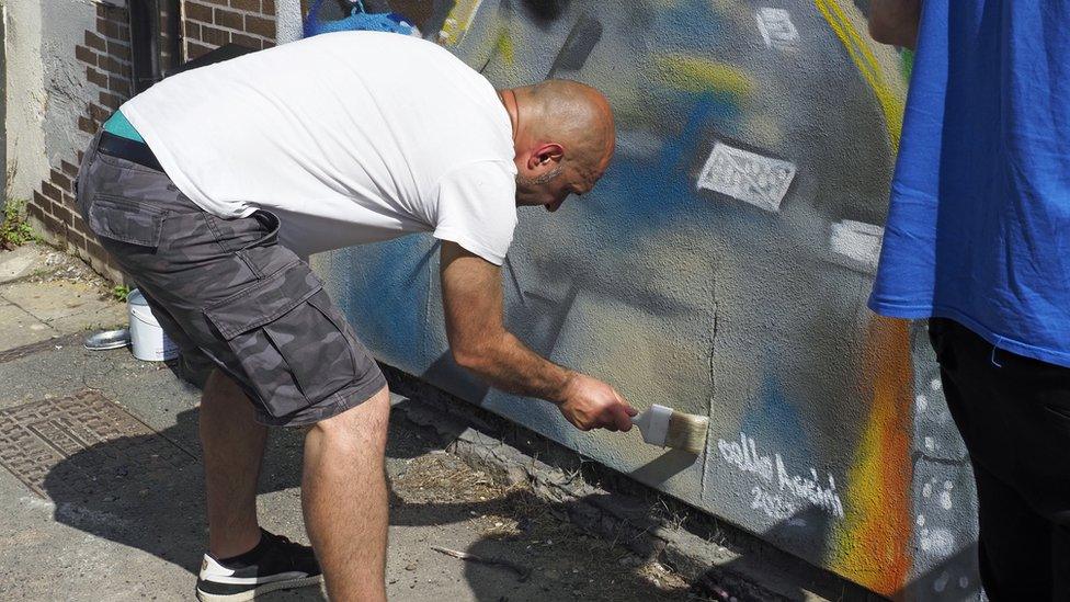 Marcello painting the wall