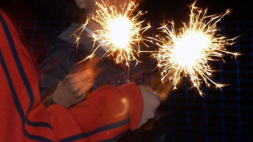 Children playing with sparklers