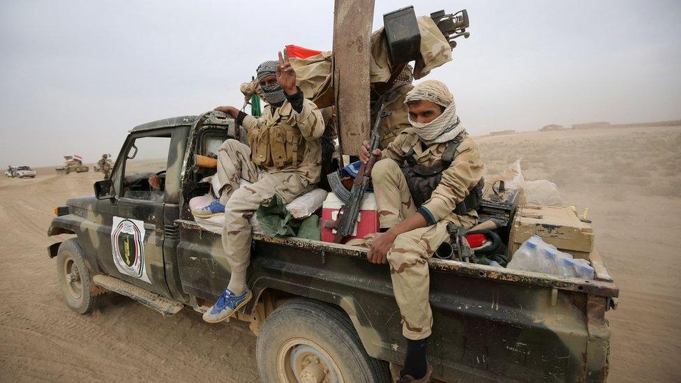 Shia militiamen from the Hashd al-Shaabi (Popular Mobilisation) enter the village of Abu Shuwayhah, south of Mosul, on 1 November 2016