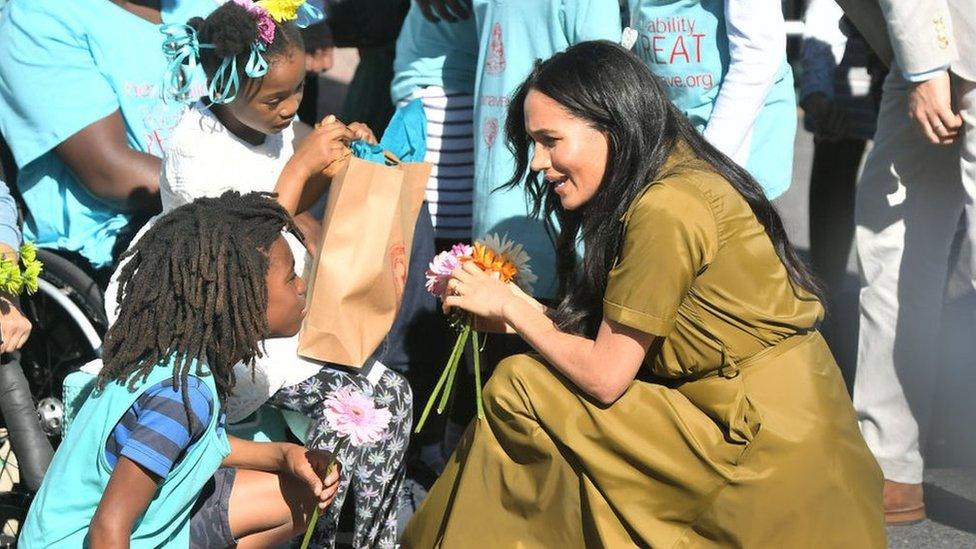 A-young-fan-offers-the-Duchess-of-Sussex-a-flower.