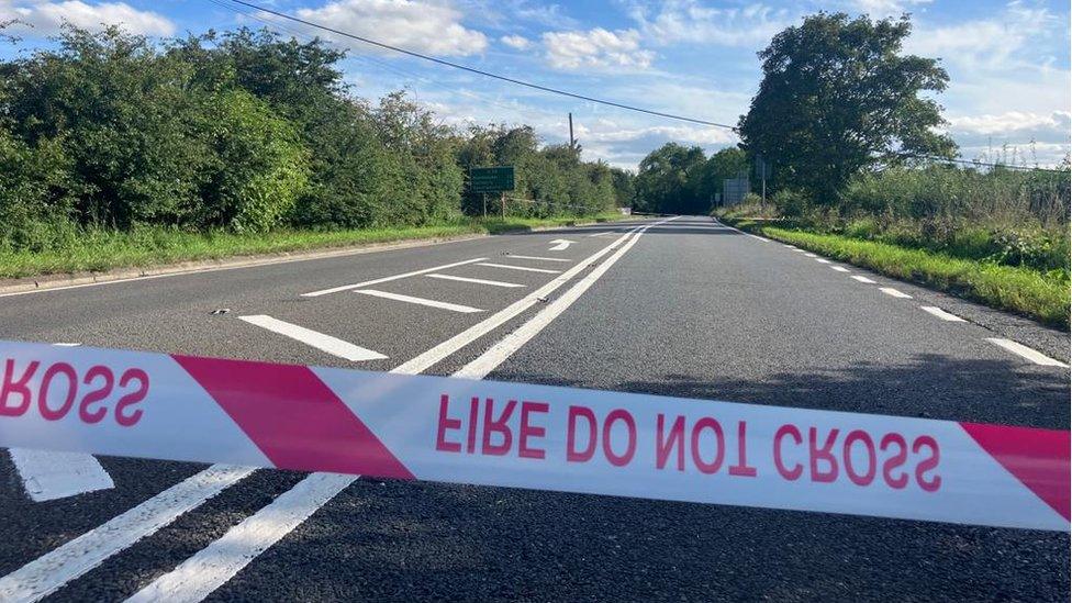 A photo of the road where the incident happened with fire "do not cross" tape across it