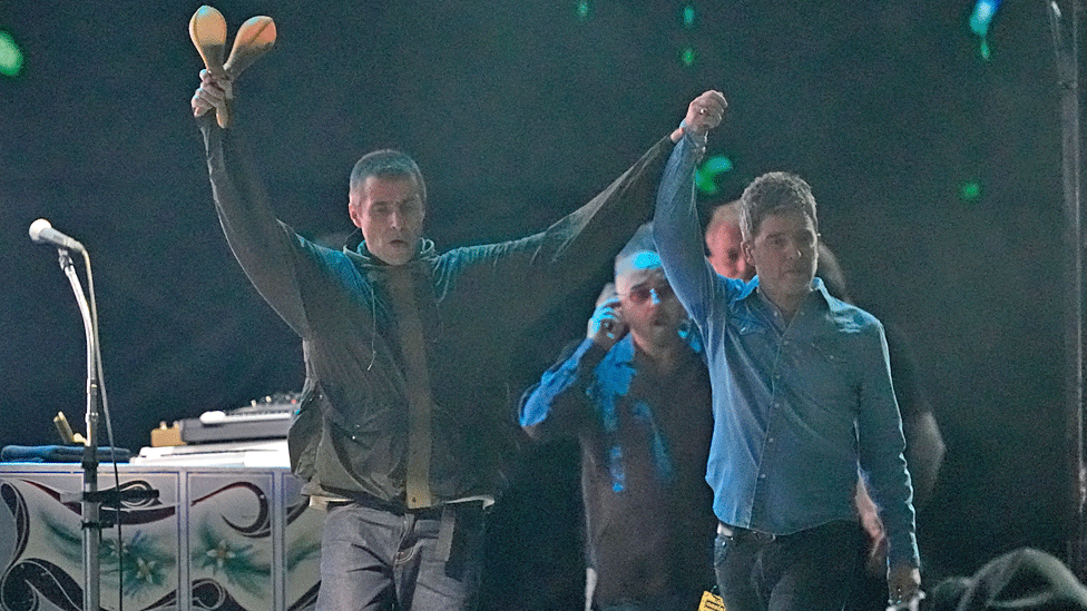 Noel and Liam Gallagher walked on stage as Liam clasped his brother's right hand aloft to a cheering crowd