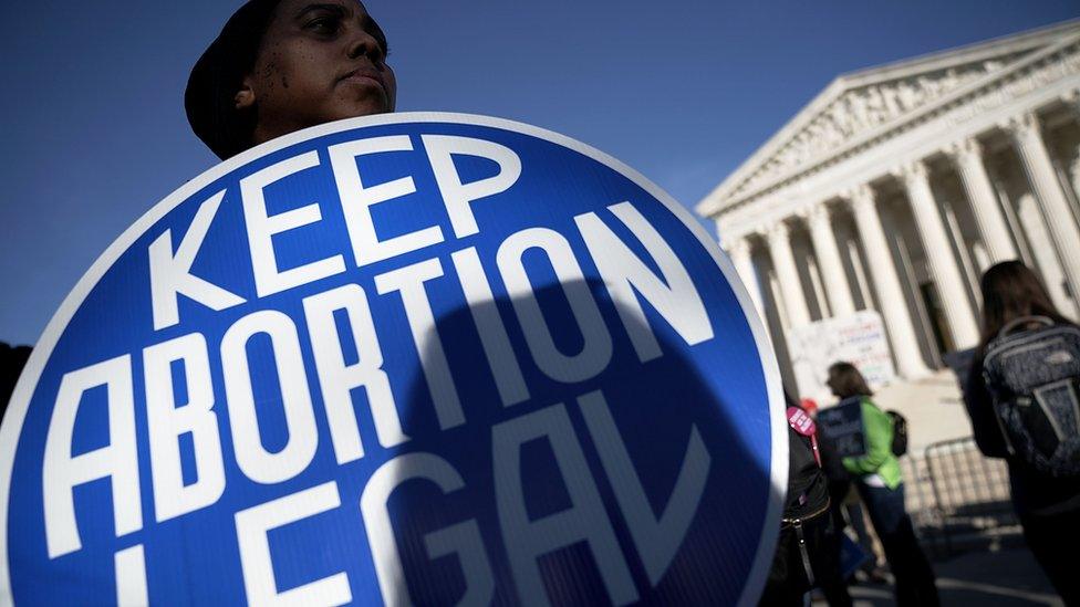 A pro-choice activist holds a sign as she counter-protests in front of the the U.S. Supreme Court during the 2018 March for Life 19 January 2018 in Washington DC