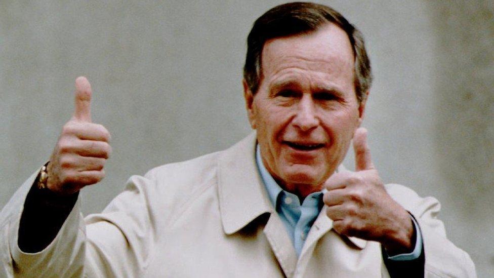 President George HW Bush, shown giving a thumbs-up sign