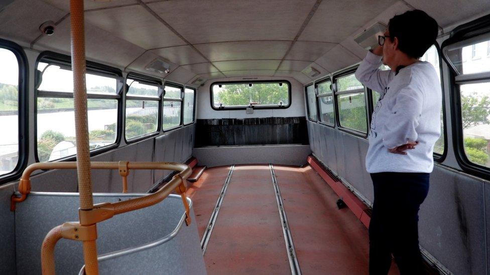 Empty top deck of the double decker bus, Dawn Emmerson looks at the space