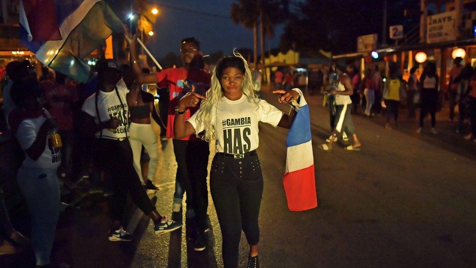 People celebrate in the streets after hearing of the confirmed departure of former Gambian leader Yahya Jammeh in Banjul on January 21, 2017