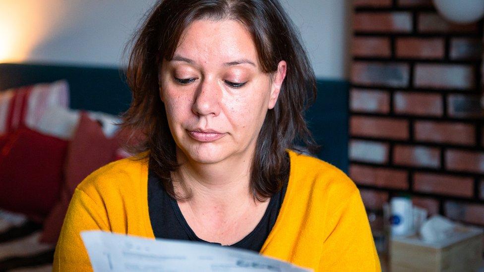 Woman checking bills at home