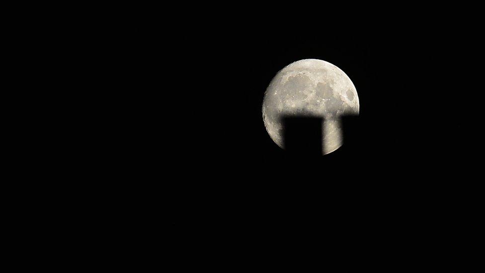 Super blue moon between chimney tops