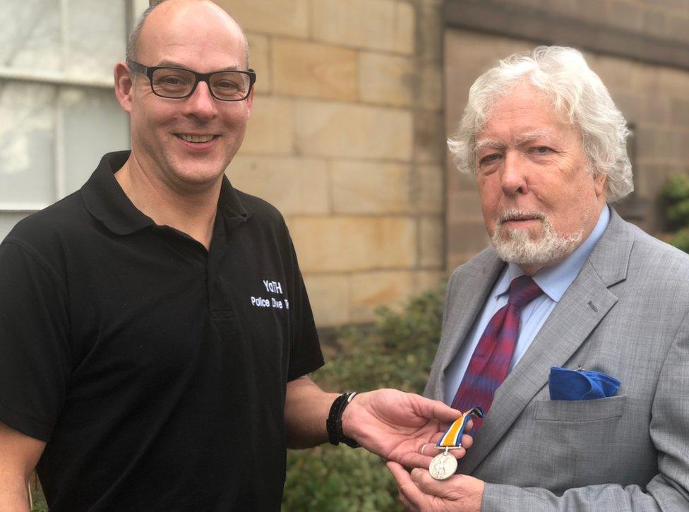 Police diver Roger Bennett and L/Cpl Stephen Smith's great-nephew Julian Cliff