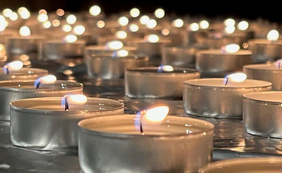 Candles lit at the vigil by some of the families affected