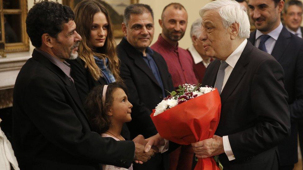 President Pavlopoulos (2nd R) congratulates migrant fishermen, 2 Jan 19