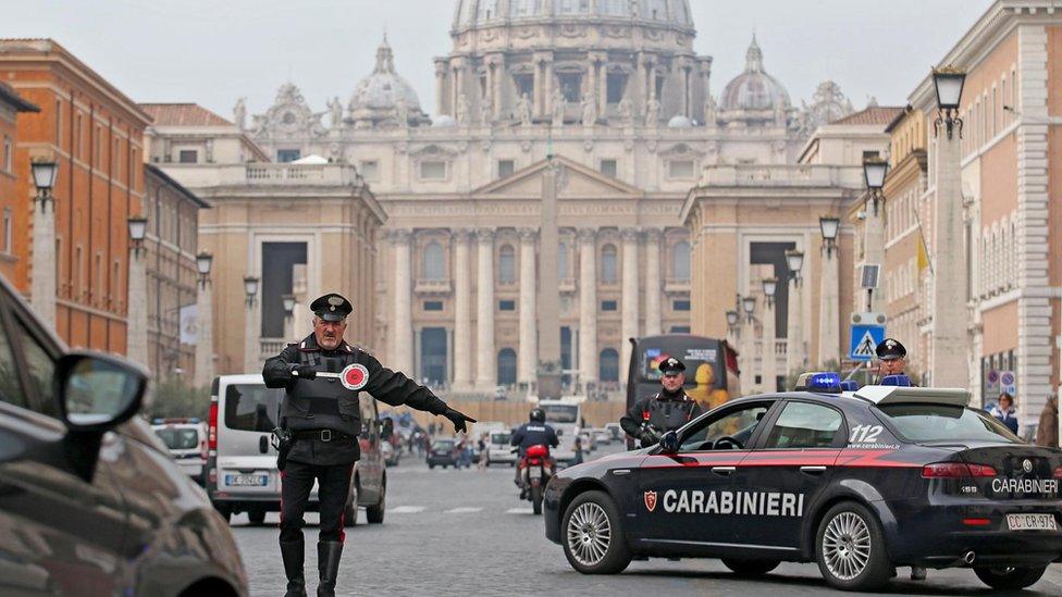 Italian Carabinieri police stand guard at a checkpoint in Conciliazione Street, next to St. Pater's Square, in Rome.