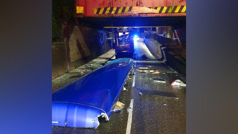 The bus with its roof on the street