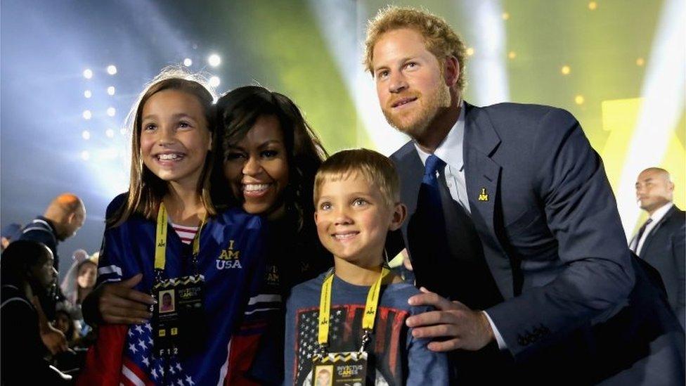 Michelle Obama and Prince Harry pose with children of servicemen and women competing in the Invictus Games