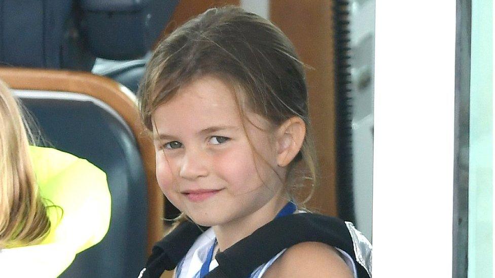 Princess Charlotte smiles as she cheers on her parents, the Duke and Duchess of Cambridge, during the charity sailing regatta