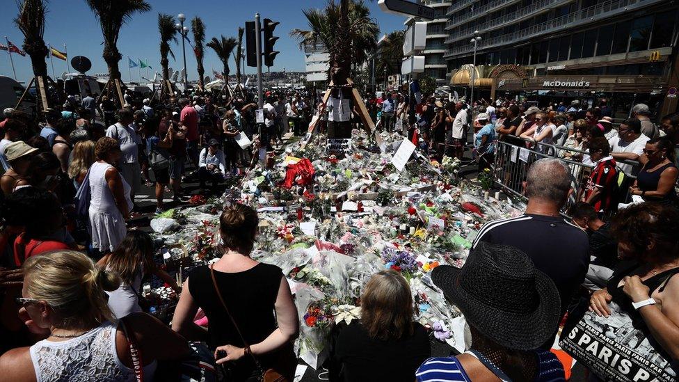 People gather to lay tributes on the Promenade des Anglais on 16 July 2016