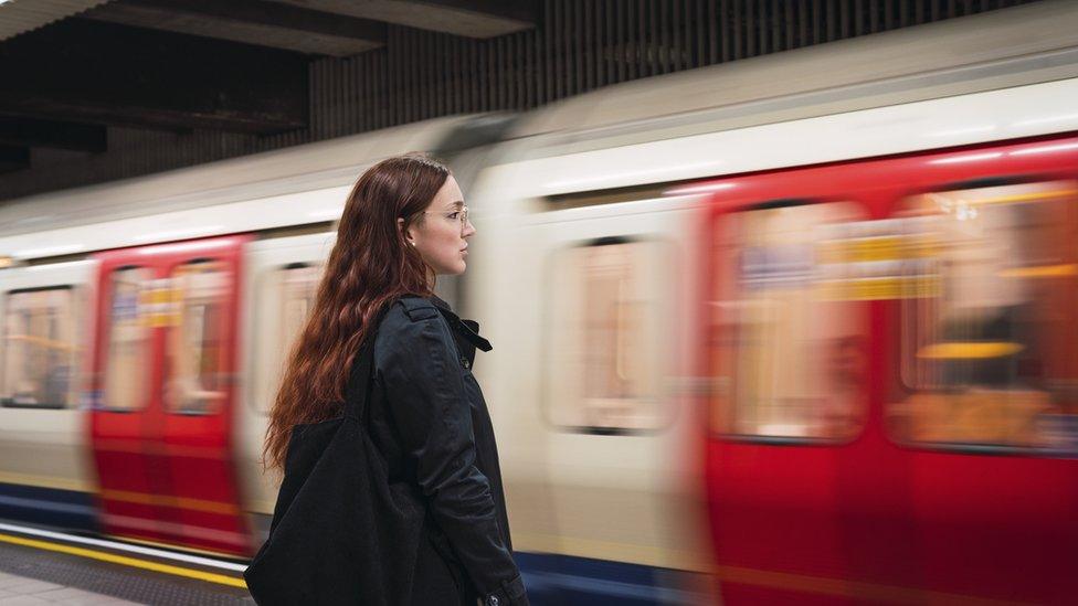 woman waits for tube