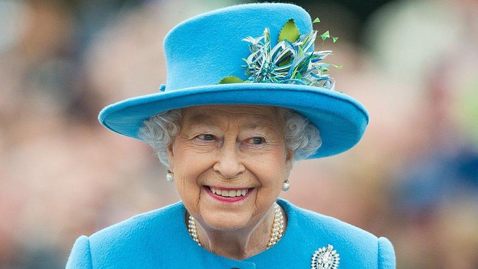 Queen Elizabeth II in a blue coat and hat