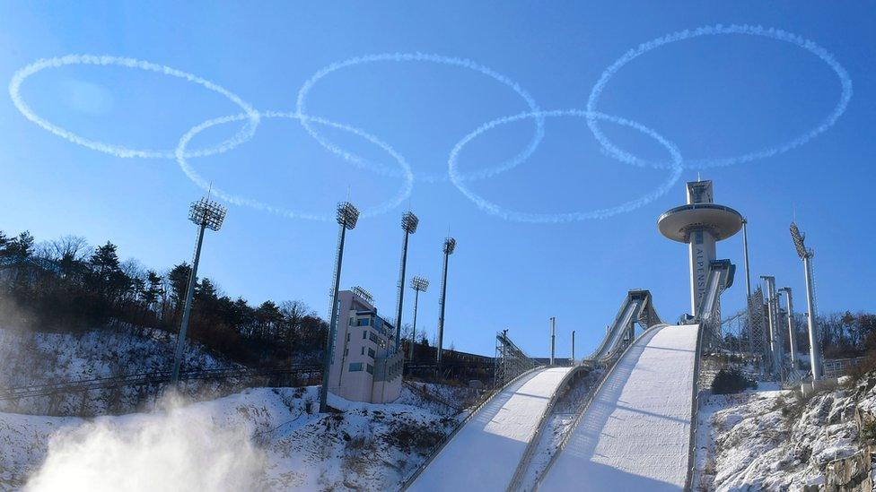 Members of the South Korean air force Black Eagle aerobatic team perform above the ski jump venue of the Pyeongchang 2018 winter Olympics