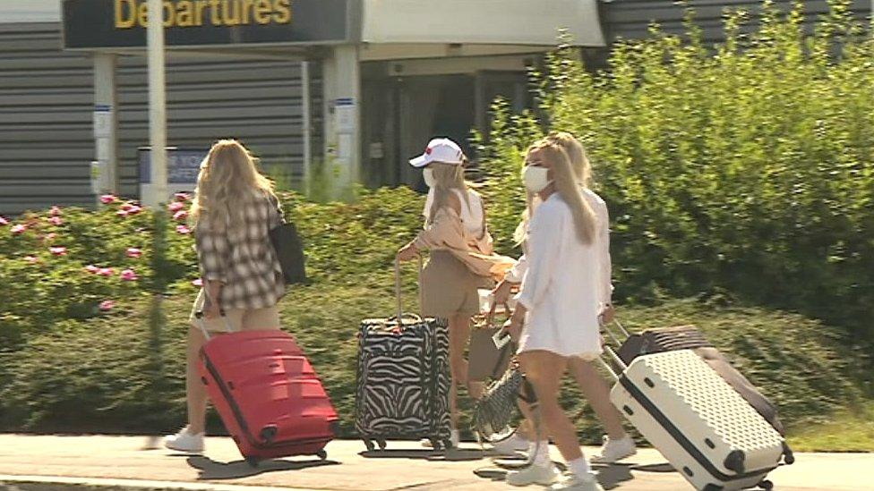 Passengers arrive at the airport for holidays