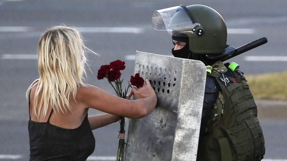 woman-protesting-against-riot-police-belarus.