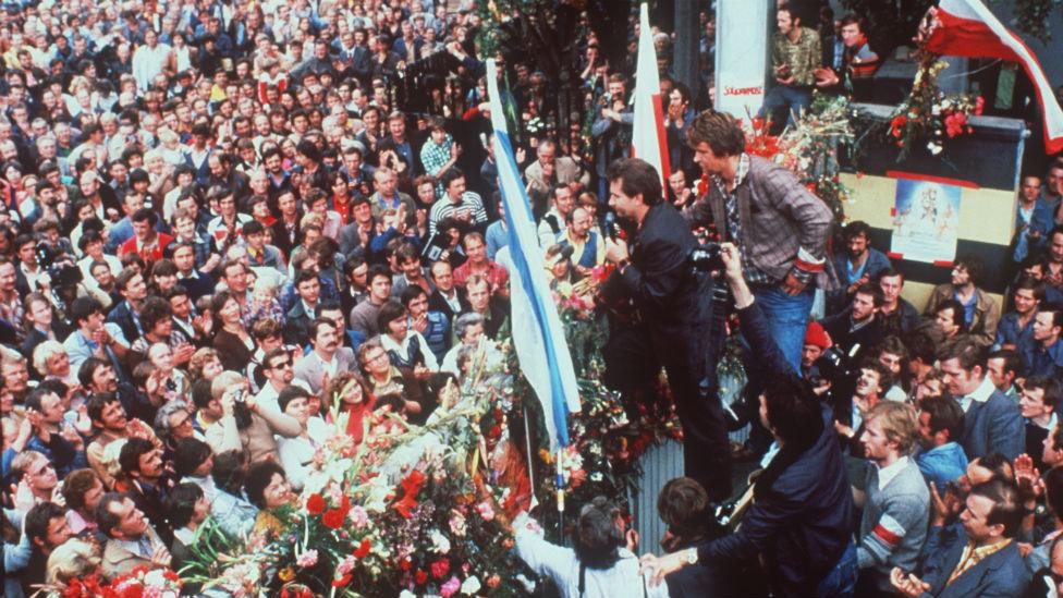 Friends and relatives of striking workers listen to the news given by Lech Walesa outside the gates of the Lenin Shipyard in Gdansk