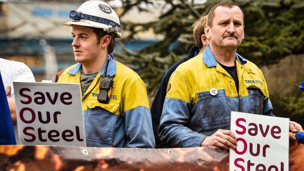 Steel workers holding "save our steel" placards