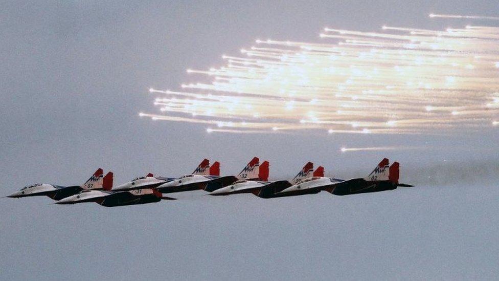 MiG-29 fighter aircraft of the Russian Air Force launch flares as they fly in formation at the Zhuhai Air Show in China (01 November 2016)