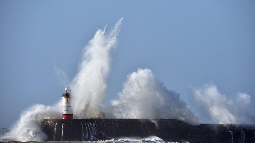 Waves crash into lighthouse in Newhaven