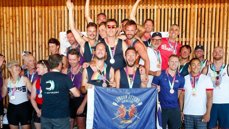 The London Otter Rowing Club Open Eight team on the podium after winning the gold medal