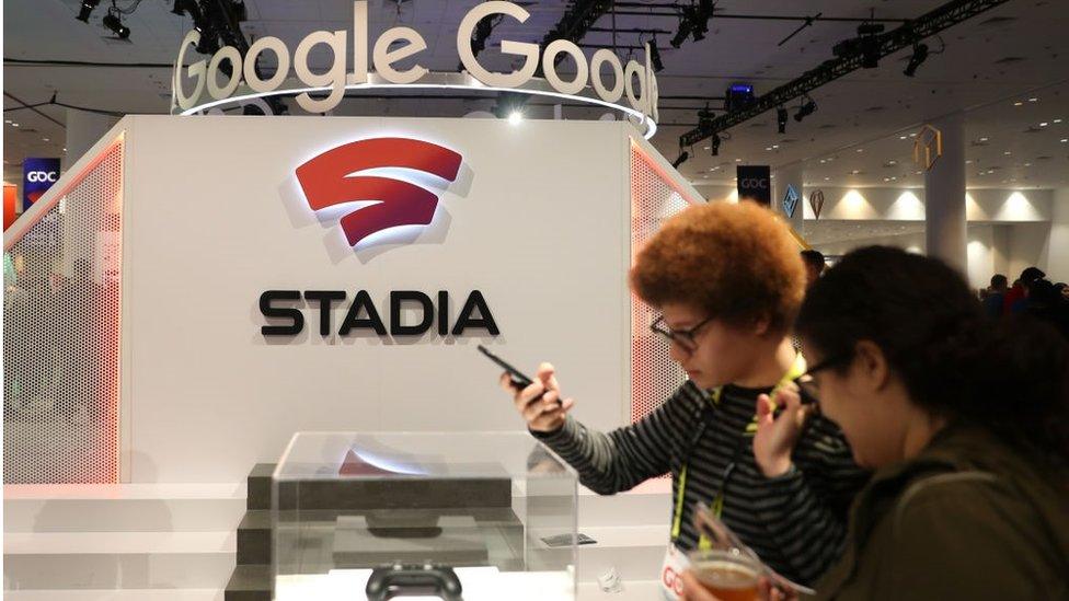 Attendees look at the new Stadia controller on display at the Google booth at the 2019 GDC Game Developers Conference on March 20, 2019 in San Francisco, California.