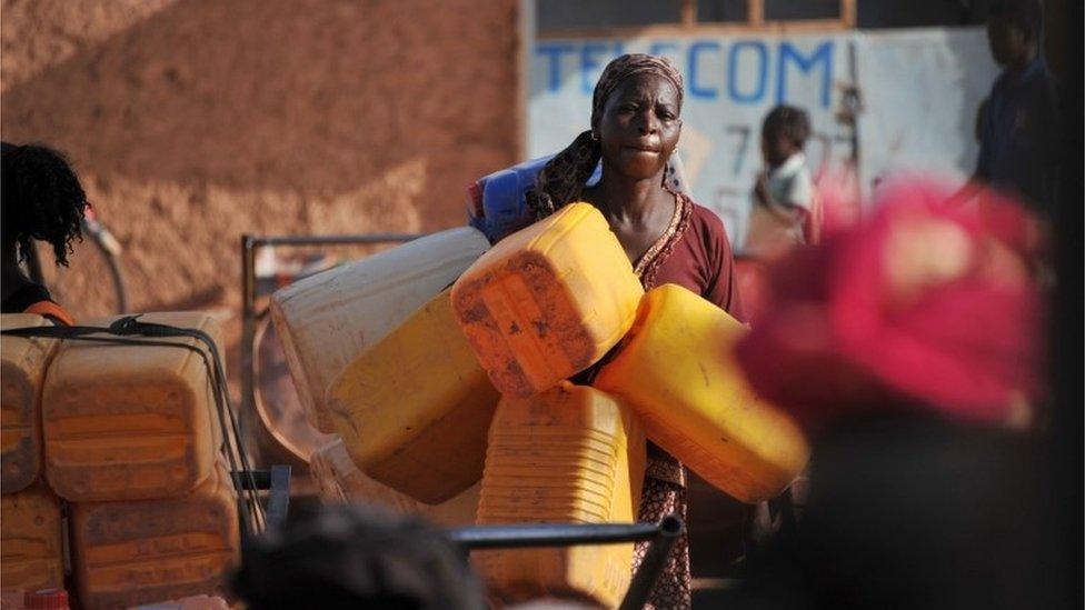 A woman carries plastic water containers in the Taptenga suburb of Ouagadougou, Burkina Faso - Wednesday 4 May 2016