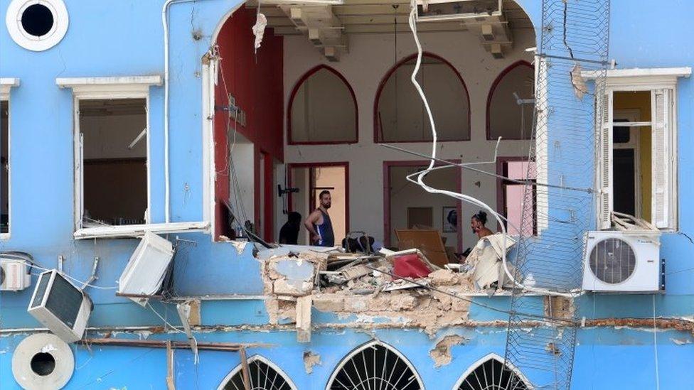 Men inspect a damaged building in Beirut. Photo: 6 August 2020