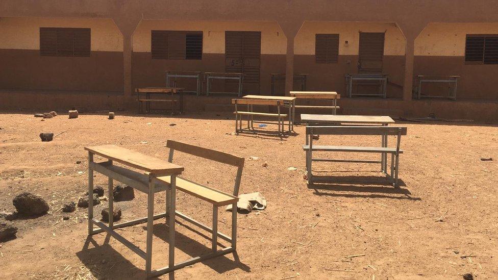 School desks outside an abandoned school in northern Burkina Faso