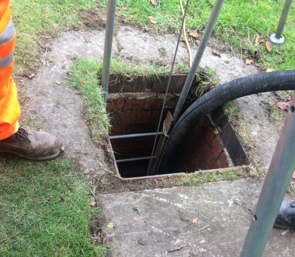 Manhole entrance to drain