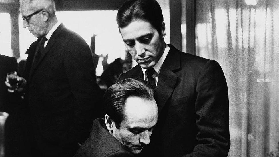 Frederico "Fredo" Corleone holds his brother Michael Corleone at a family funeral in Francis Ford Coppola's The Godfather: Part II