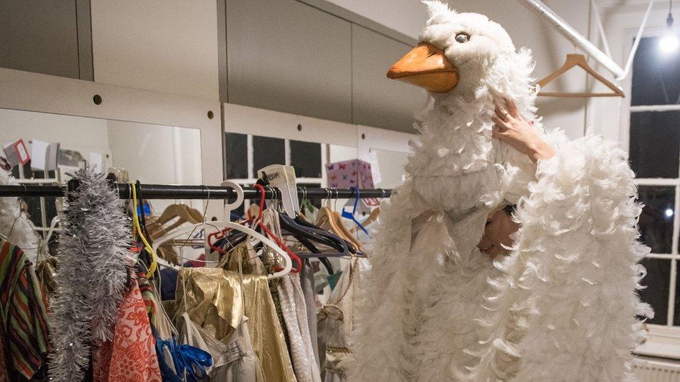 'Priscilla The Goose' gets into costume in a dressing room before a performance of the pantomime 'Mother Goose' at Wilton's Music Hall in London