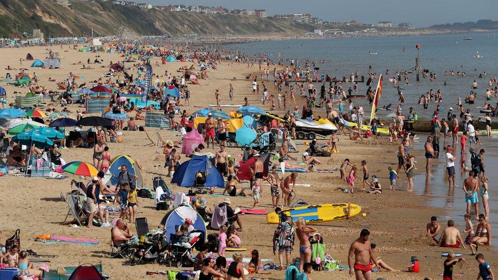 People crowded on to Boscombe Beach in Dorset in sunny weather