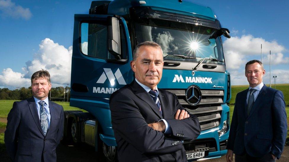 Image of lorry and staff after QIH rebranding to Mannok