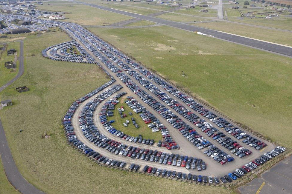 Aerial view of cars being stored on airport runways