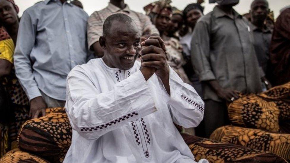 Adama Barrow, hands clasped and surrounded by supporters at a rally in Talinding on 29 November