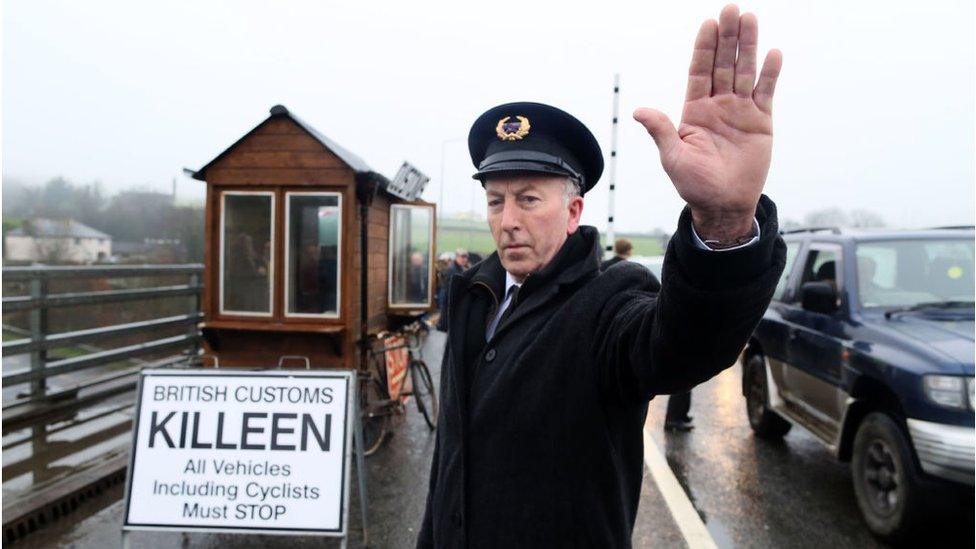 Demonstrators dressed as custom officials set up a mock customs checkpoint at the border crossing in Killeen, near Dundalk