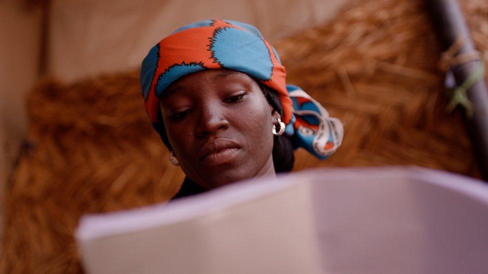 A woman looking at a notebook