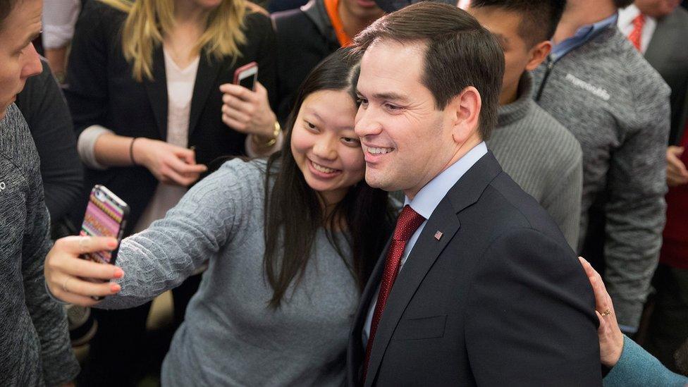 Marco Rubio taking a selfie with a young woman